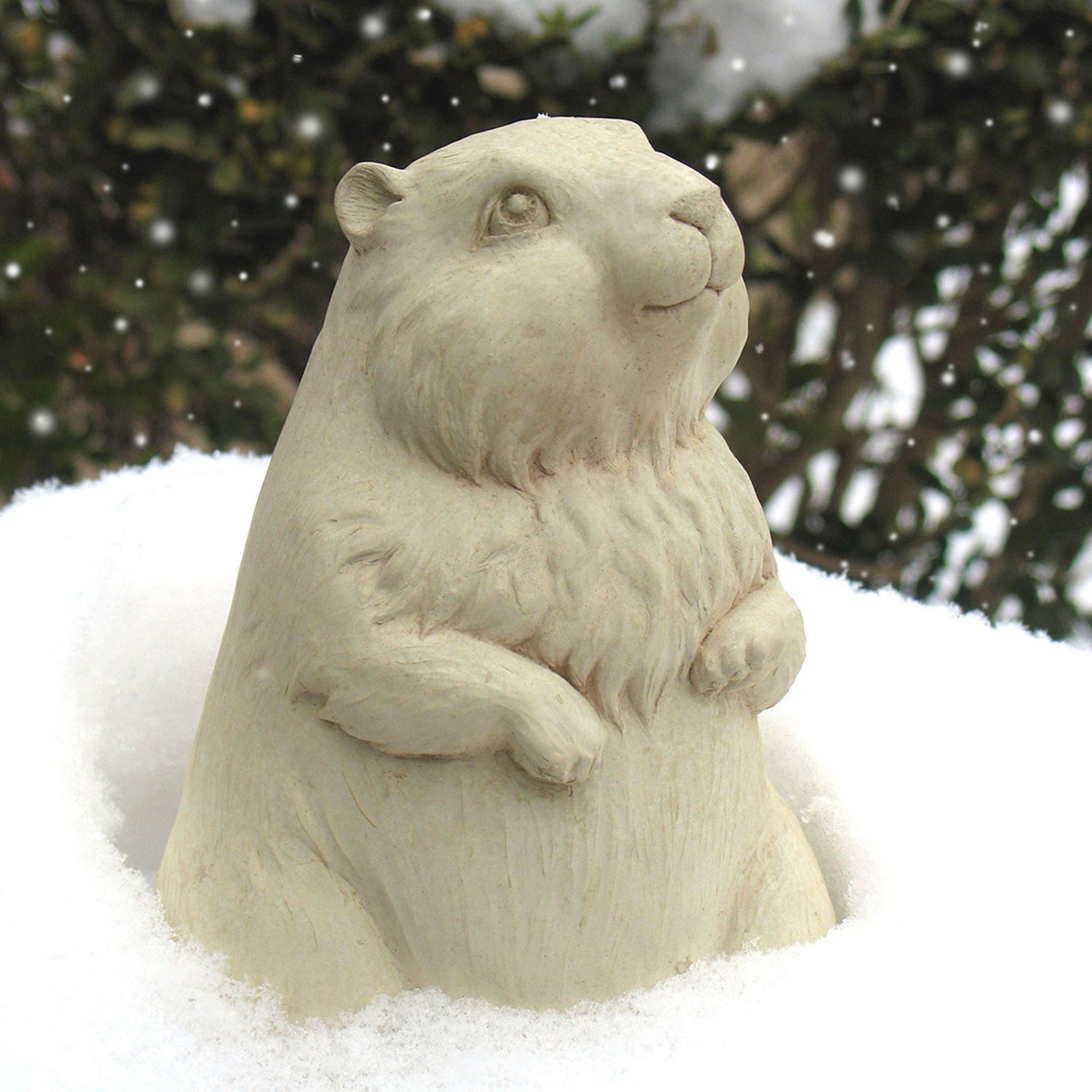 Handcrafted stone groundhog sculpture displayed outdoors in the snow by Carruth Studio